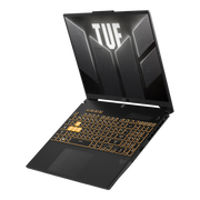 A TUF Gaming F16, with the lid open and TUF Gaming logo on screen, floating above a desolate landscape